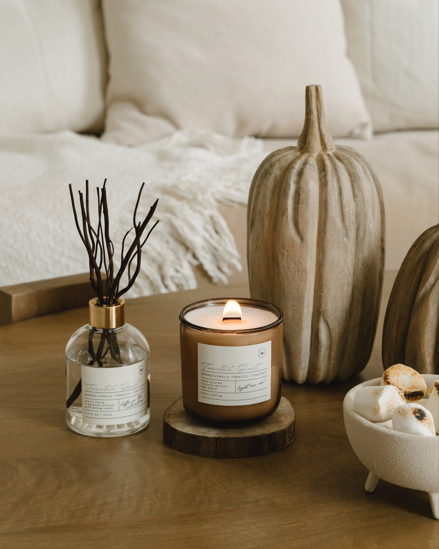 Candle and decorative items on a wooden table with a cozy background