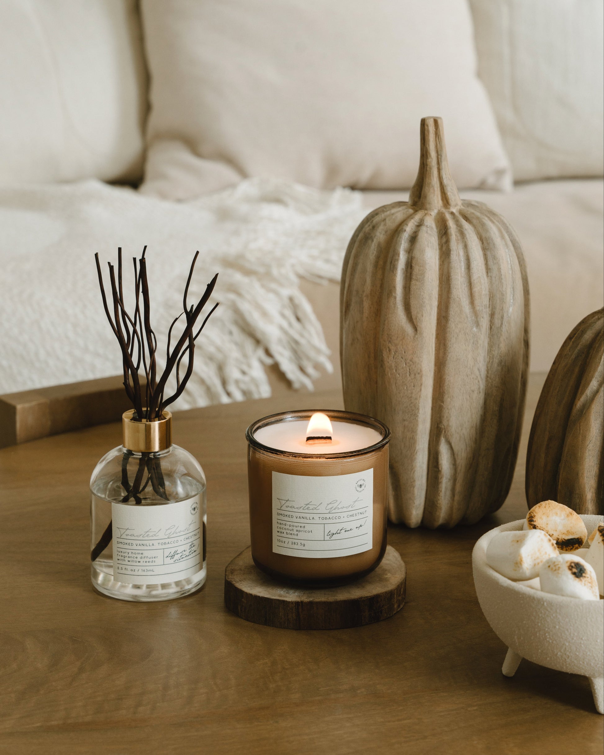 Candle and decorative items on a wooden table with a cozy background
