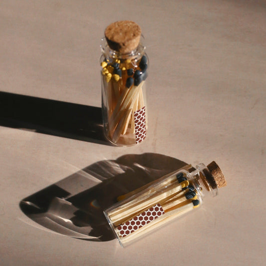 yellow and black matches in a vial